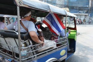 Tuk-tuk with a protester